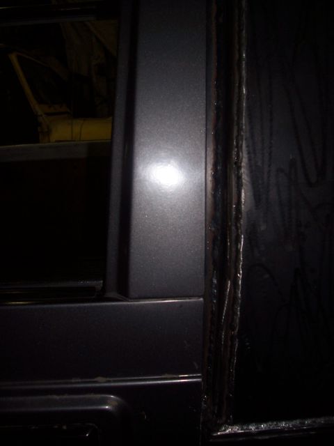 1988 Suzuki Samurai - The image shows a close-up of the door frame and the edge of a vehicle's body panel.