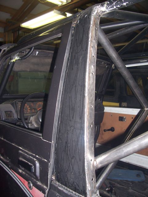 1988 Suzuki Samurai - The interior of a 1988 Suzuki Samurai shows a custom roll cage and dashboard details.