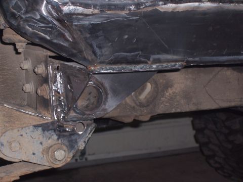 1988 Suzuki Samurai - Close-up view of custom fabrication and welding on a vehicle's chassis, likely for off-road modifications.