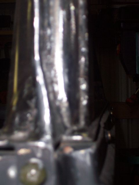 1988 Suzuki Samurai - Close-up view of chrome roll cage tubing, likely part of a custom modification.