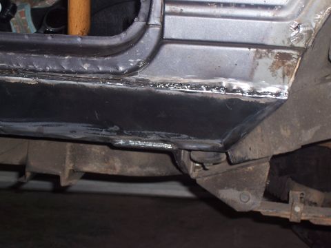 1988 Suzuki Samurai - Close-up of a 1988 Suzuki Samurai's rocker panel undergoing repair with new welds.