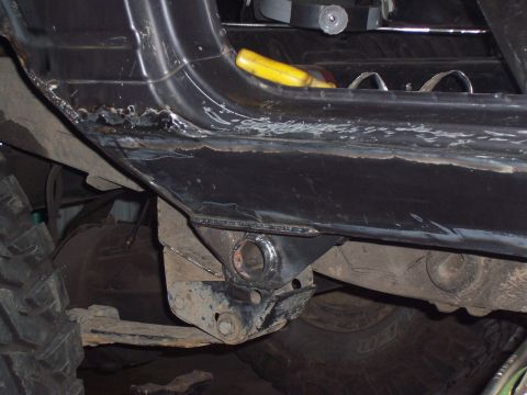 1988 Suzuki Samurai - This photo shows modifications being made to the frame of an off-road vehicle, focusing on suspension mounting points.