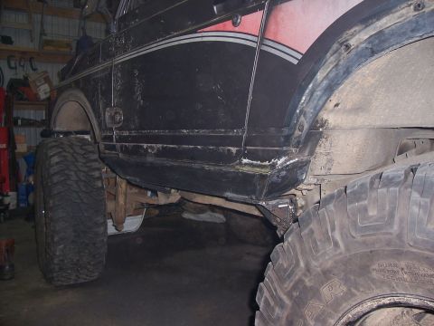 1988 Suzuki Samurai - This off-road vehicle has large tires and visible rust on its lower body panels.