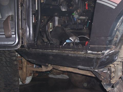 1988 Suzuki Samurai - The interior of a modified off-road vehicle is visible, with focus on the driver's side door and rocker panel.