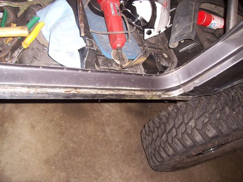 1988 Suzuki Samurai - Tools and a tire are visible inside a vehicle's interior.
