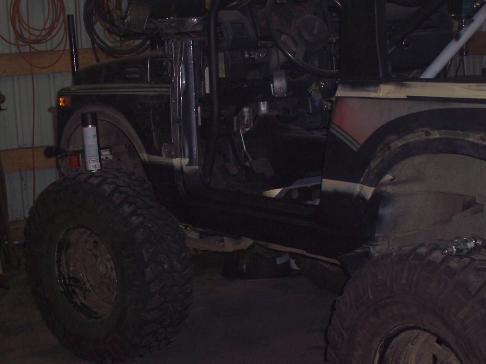 Black off-road vehicle interior with large tires and roll cage
