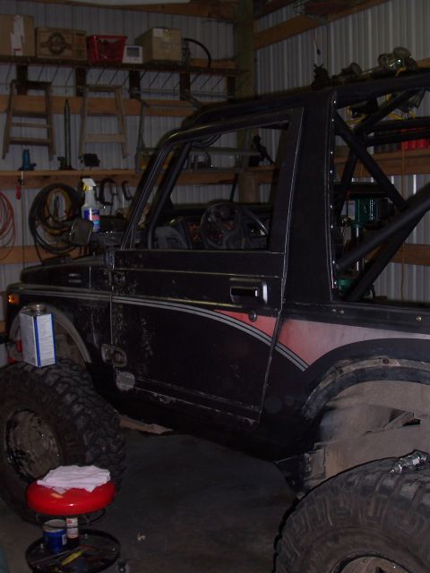 1988 Suzuki Samurai - This modified 1988 Suzuki Samurai features a custom roll cage and large off-road tires, suggesting it's built for terrain.
