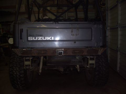 1988 Suzuki Samurai - The rear of a Suzuki Samurai is shown with a custom bumper and roll cage structure.