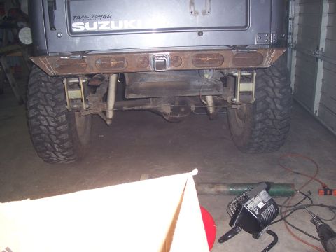 1988 Suzuki Samurai - Rear view of a 1988 Suzuki Samurai showing its suspension and custom bumper.