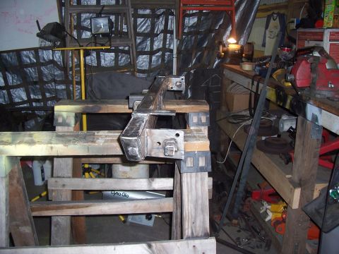 1988 Suzuki Samurai - Custom metal fabrication part on sawhorses in a workshop setting.