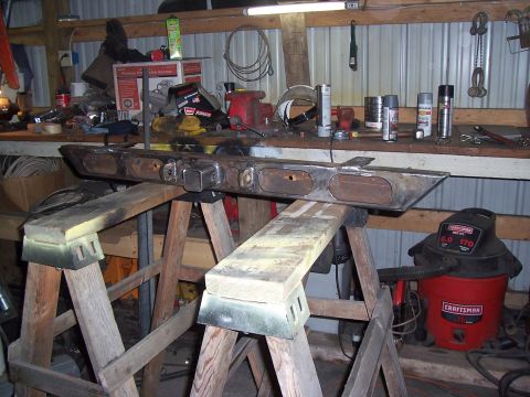 1988 Suzuki Samurai - A custom-fabricated bumper, possibly for an off-road vehicle, is supported by sawhorses in a workshop setting.