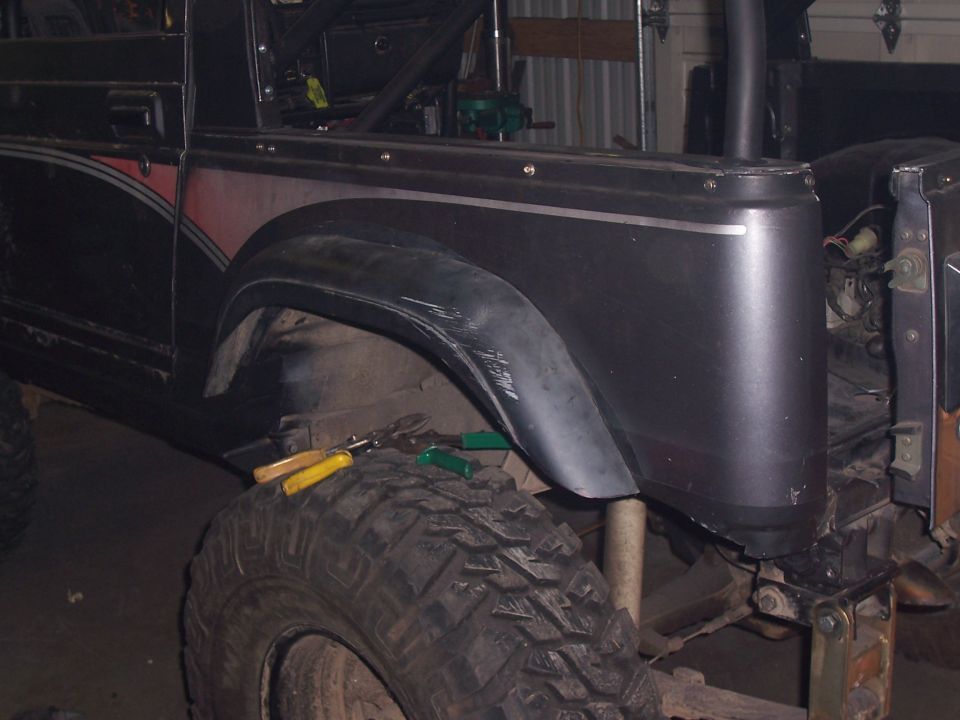 Modified Suzuki Samurai fender and large off-road tire