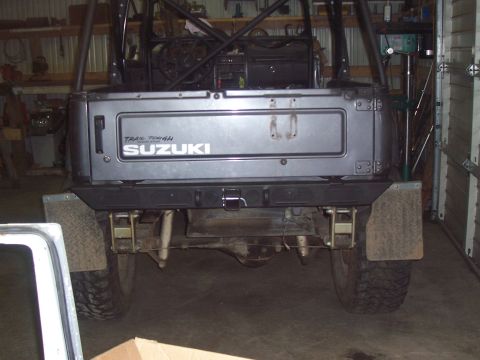1988 Suzuki Samurai - Rear view of a 1988 Suzuki Samurai, modified with an aftermarket bumper and suspension components.