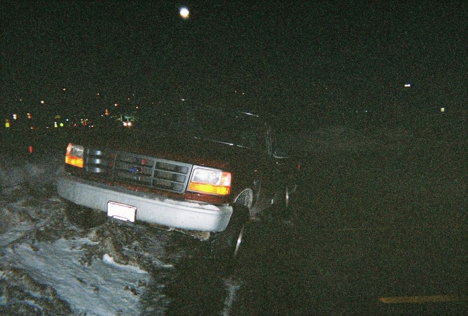 1996 Ford F-150 front grille and headlights at night
