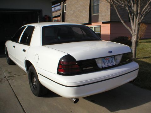 2000 Ford Crown Victoria - Rear view of a white 2000 Ford Crown Victoria with a black trim panel and tinted taillights.