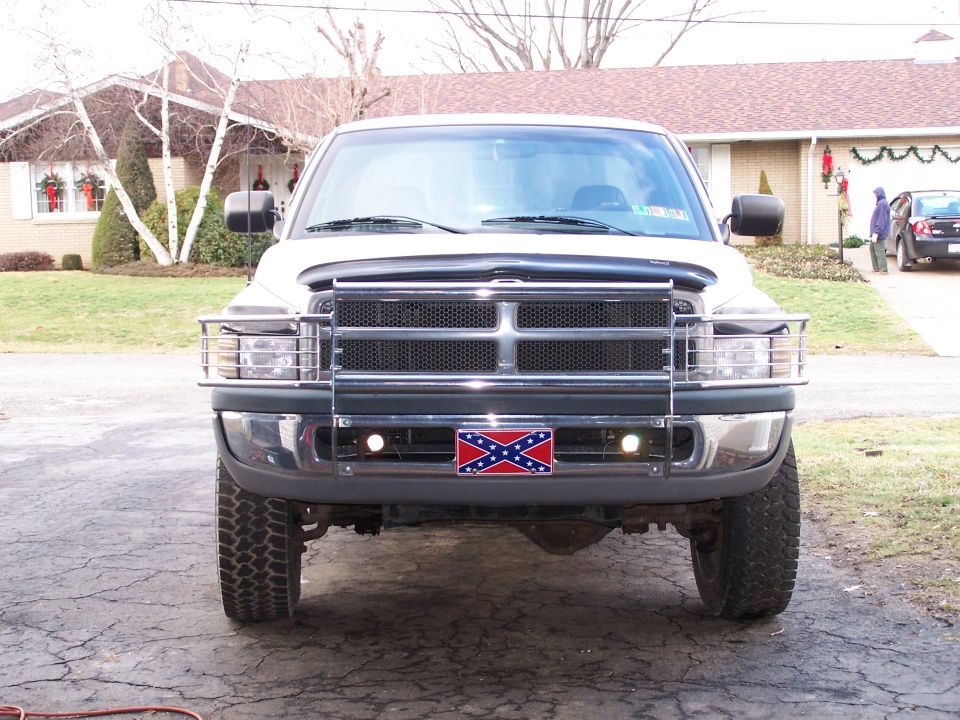 Front view of a white 1997 Dodge 2500 pickup truck with a Confederate flag license plate