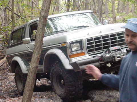 1978 Ford Bronco - This 1978 Ford Bronco is navigating a wooded trail with a winch mounted on the front bumper.