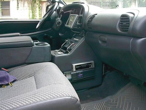 2001 Dodge 1500 - The interior of a truck shows the center console with aftermarket electronics and a GPS unit mounted on the dashboard.