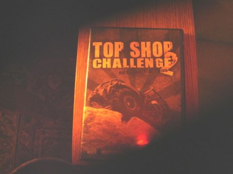 1992 Ford Bronco - Dimly lit photograph of a "Top Shop Challenge 2" DVD case, not a technical document.