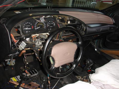 1993 Ford Taurus - The interior of a 1993 Ford Taurus shows a disassembled dashboard with exposed wiring and components.