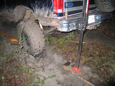 1995 Ford Bronco - Muddy rear end of a 1995 Ford Bronco with a Hi-Lift jack ready to assist.