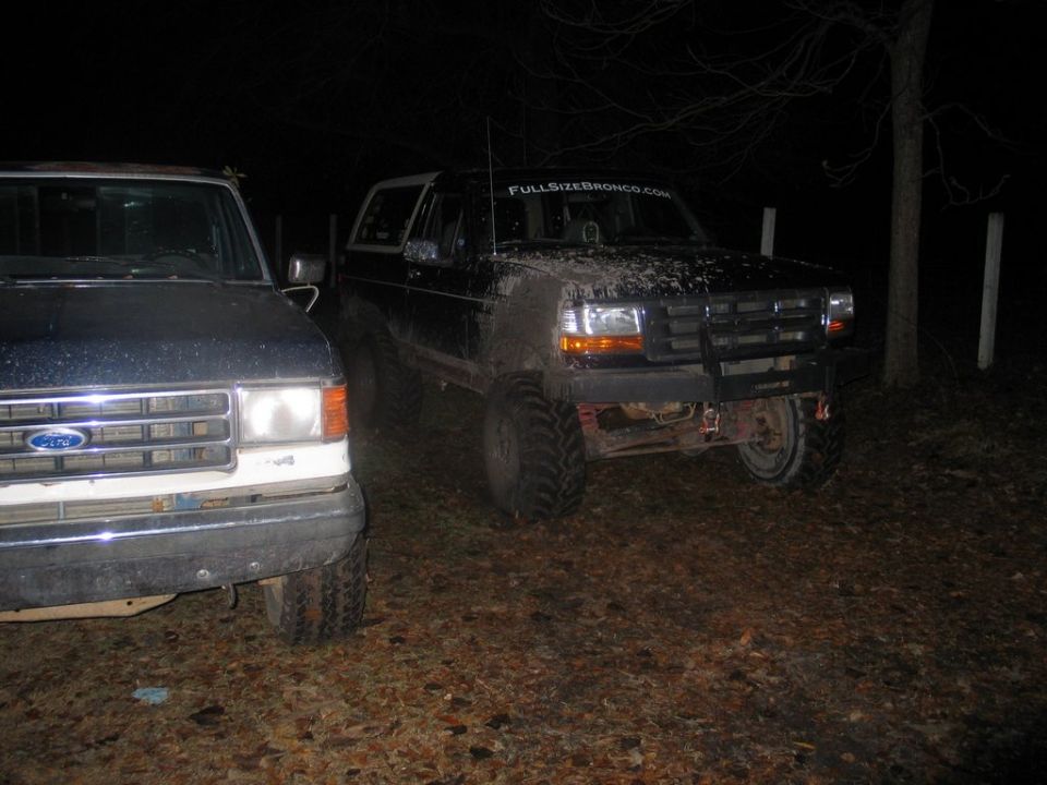 Black Ford Bronco with mud, off-road tires, and a bull bar