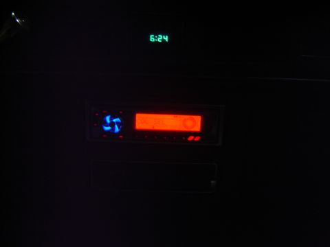 1988 Ford Crown Victoria LTD - The car's interior shows a digital clock and an aftermarket stereo system in the dark.