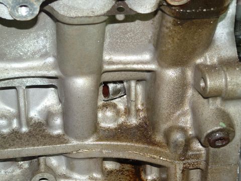 1996 Ford Probe - Engine block casting detail, showing internal passages and oil staining.