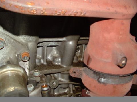 1996 Ford Probe - Close-up view of an engine block and exhaust manifold, with visible text on a pipe.
