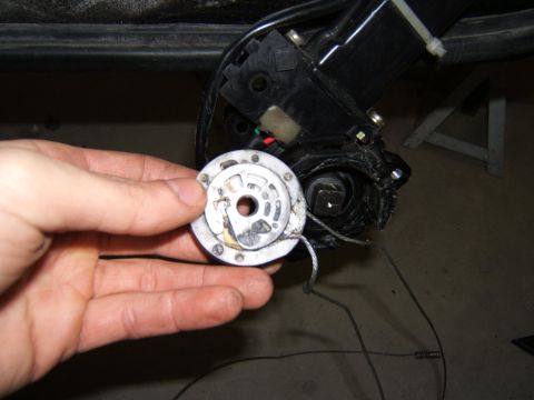 1993 Ford Probe - Close-up of a detached window regulator part and its associated mechanism.