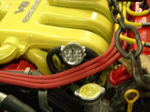 1996 Ford Probe - Engine bay detail showing a V6 DOHC 24-VALVE engine with a gauge attached to a hose.