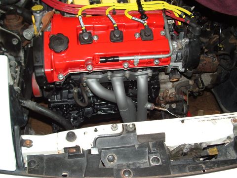 1996 Ford Probe - Close-up view of a modified engine, showing the red valve cover and exhaust headers.