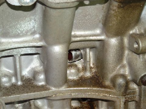 1996 Ford Probe - Engine block detail, showing casting marks and oil residue.