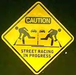 1986 Ford Bronco - This sign warns of street racing activity.