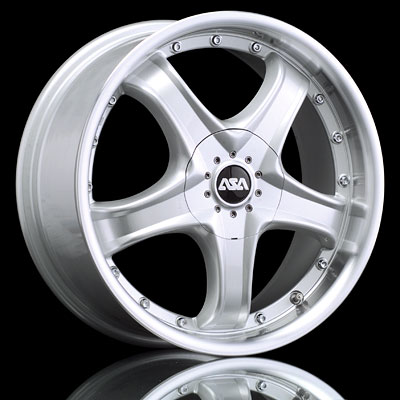 1986 Ford Bronco - A single silver ASA wheel is shown against a black background, reflecting on a surface below.