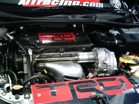1986 Ford Bronco - Engine bay details with prominent TRD branding and a supercharger system.
