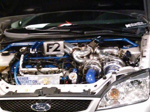 1986 Ford Bronco - Modified engine bay with twin turbochargers and custom blue piping.