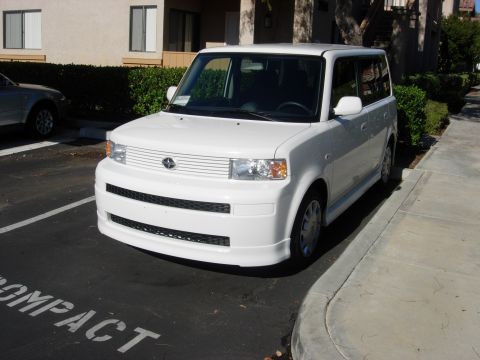 2006 Scion xB - A white Scion xB is parked in a compact parking space. The front of the vehicle is facing the camera.