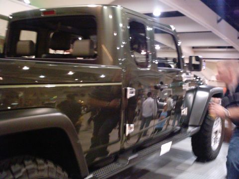 1986 Ford Bronco - This Jeep Gladiator pickup truck is shown from the side, highlighting its passenger doors and bed area.