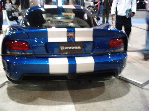 1986 Ford Bronco - Rear view of a blue Dodge Viper with white racing stripes and a visible Dodge emblem.