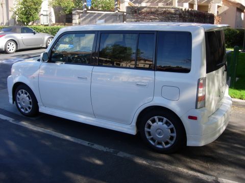 2006 Scion xB - The rear three-quarter view of a white 2006 Scion xB shows its distinctive boxy shape and rear spoiler.