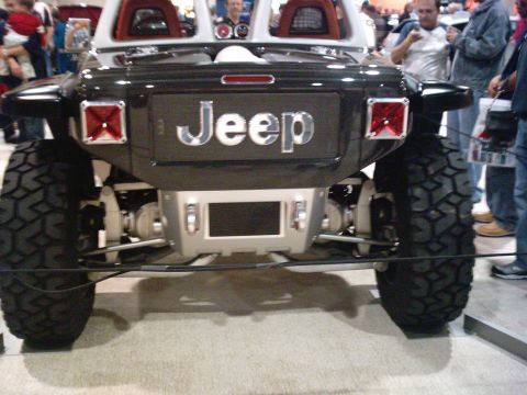 1986 Ford Bronco - This custom Jeep features prominent "JEEP" badging on its rear panel and oversized off-road tires.
