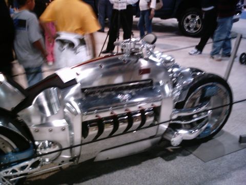 1986 Ford Bronco - A highly customized motorcycle with a V-engine is displayed indoors.