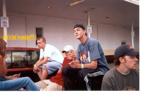 2004 Ford Taurus - A group of friends are gathered outdoors, with one person in the foreground looking towards the camera.