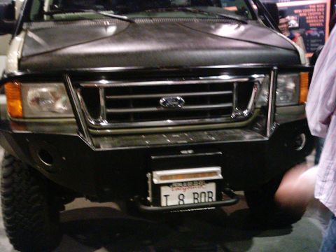 1986 Ford Bronco - Front view of a Ford E-Series van with a custom bumper and grille.