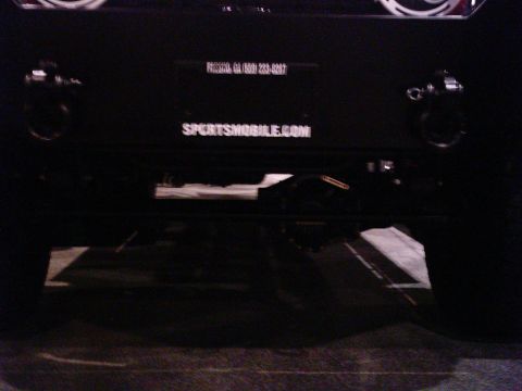 1986 Ford Bronco - Rear view of a black SUV, showing a tow hitch and the website SPORTSMOBILE.COM.