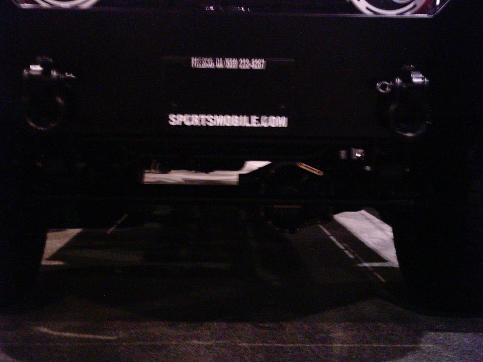 Black SUV rear with tow hitch and SPORTSMOBILE.COM text