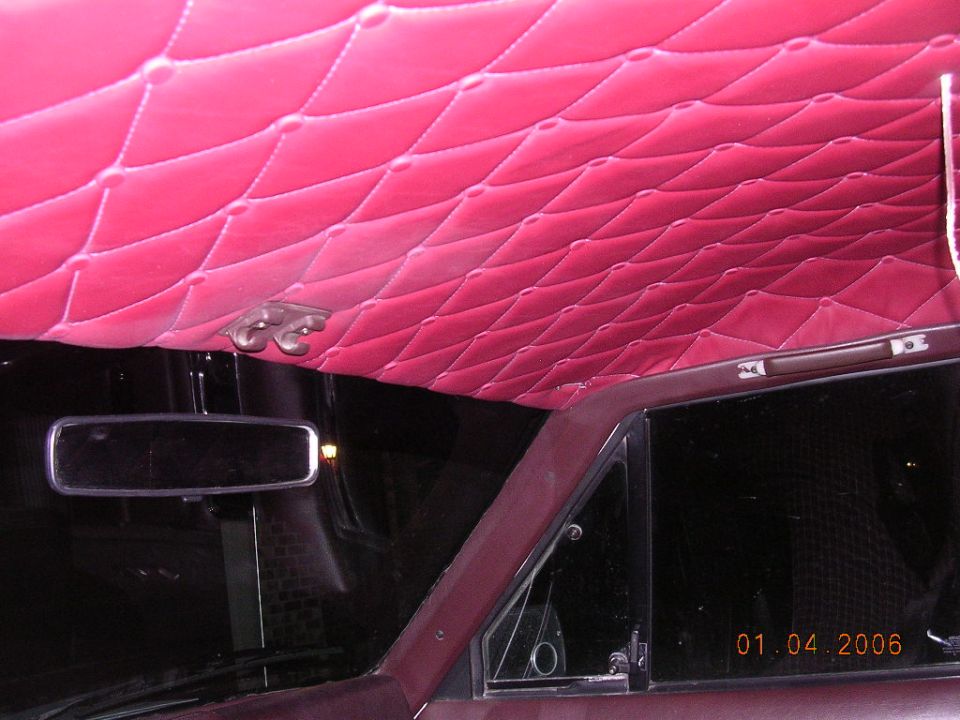 Pink tuck-and-roll quilted vinyl headliner in dark-trimmed car interior