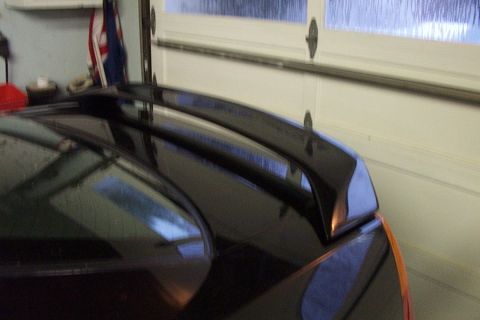 1999 Chrysler 300M - Close-up of a black car spoiler mounted on the trunk.