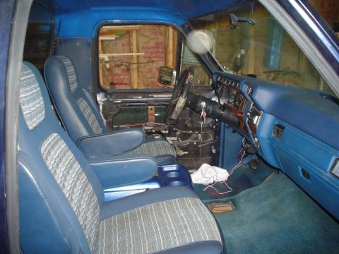 1984 Ford Bronco - Interior view of a blue truck, showing the front seats and dashboard area.